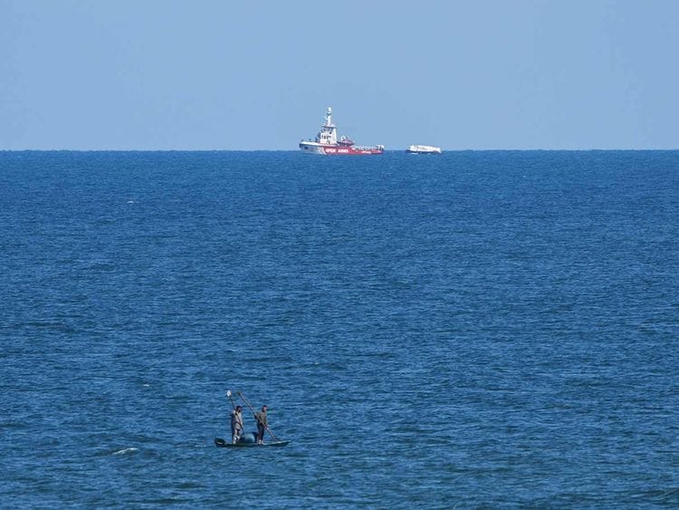 A ship belonging to the Open Arms aid group approaches the shores of Gaza towing a barge with 200 tons of humanitarian aid on Friday, March 15, 2024. 