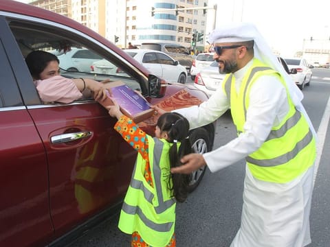 A young volunteer hands over an Iftar meal box to a motorist in Sharjah City. The event, organised by the Sharjah Chamber of Commerce and Industry (SCCI) reinforces corporate social responsibility, generosity, compassion, and solidarity.