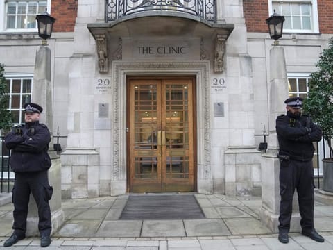 Police officers stand guard outside The London Clinic where Kate, Princess of Wales had a surgery.