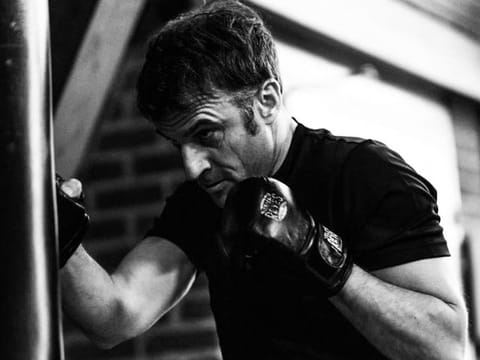An official photo showing Emmanuel Macron hitting a punch bag.