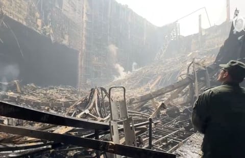 A member of the Investigative Committee of Russia at the scene of the deadly attack in Crocus City Hall concert venue, in the Moscow Region, on March 23, 2024, in this still image taken from a handout video.  