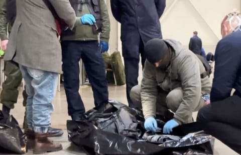 Members of the Investigative Committee of Russia examine the ammunition at the scene of the deadly shooting attack in Crocus City Hall concert venue.