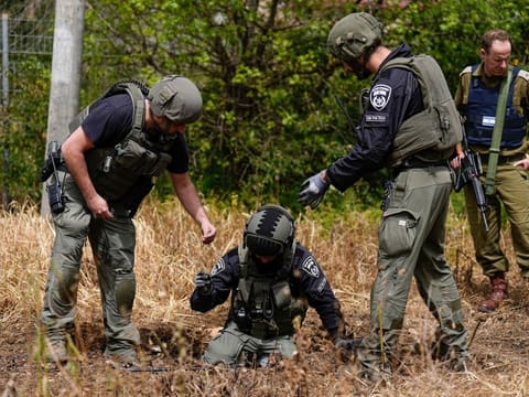 Israeli security forces examine the site hit by a rocket fired from Lebanon, in Kiryat Shmona, northern Israel on  March 27, 2024.  