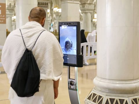 Worshippers use robots at the Grand Mosque in Mecca.  