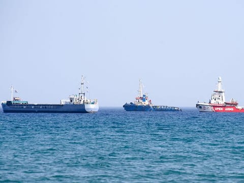 An Open Arms ship and another vessel sail towards the ship Jenifer, of the World Central Kitchen carrying food aid for the Gaza Strip, as they prepare to set sail close to the port of Larnaca in Cyprus on March 30, 2024.  