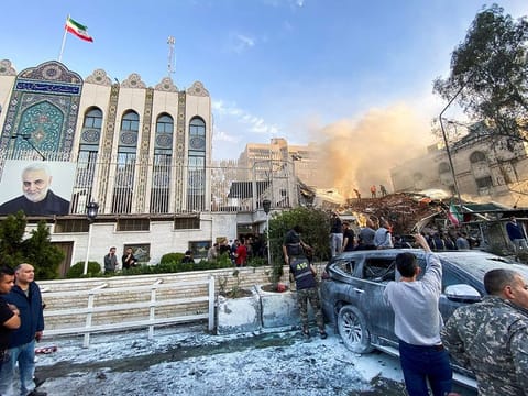  Smoke rises from the Iranian embassy annex building in Syria’s capital Monday.