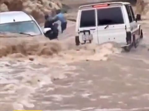 A family being rescued from a vehicle.