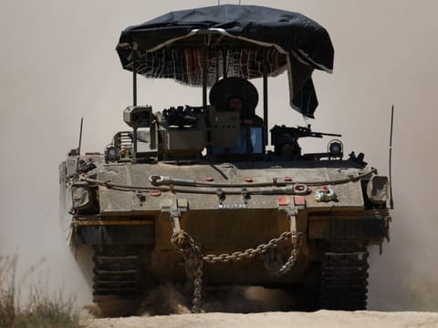 Israeli soldiers ride in a military vehicle near the Israel-Gaza border, amid the ongoing conflict between Israel and the Palestinian Islamist group Hamas, on April 3, 2024.  