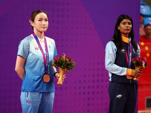 Bronze medallists Mongolia's Yesugen Oyuntsetseg and India's Nikhat Zareen (right) pose during the medal ceremony for the Women's 45-50kg.