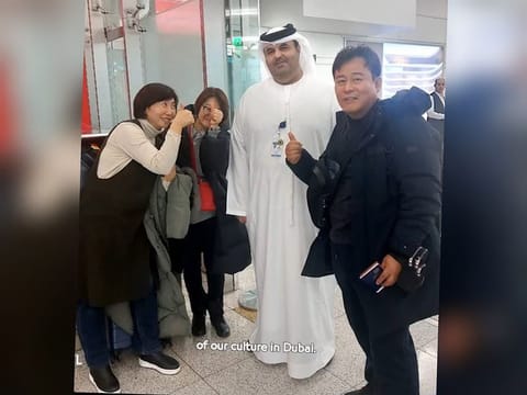 Al Habsi with the three travellers after finding their passports, seen here in an image posted on the X account of DXB