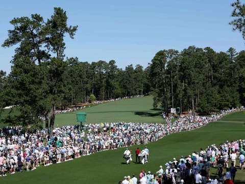 Fans watch as Tiger Woods of the US walks off the eighth tee during the final round of the 2024 Masters Tournament at Augusta National Golf Club on Sunday.