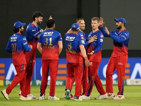 Royal Challengers Bengaluru players celebrate the wicket of Travis Head of Sunrisers Hyderabad during Match 30 on Monday.