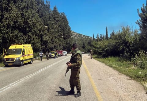 An Israeli soldier looks on at the scene, after it was reported that people were injured, amid ongoing cross-border hostilities between Hezbollah and Israeli forces, near Arab Al Aramashe in northern Israel April 17, 2024. 