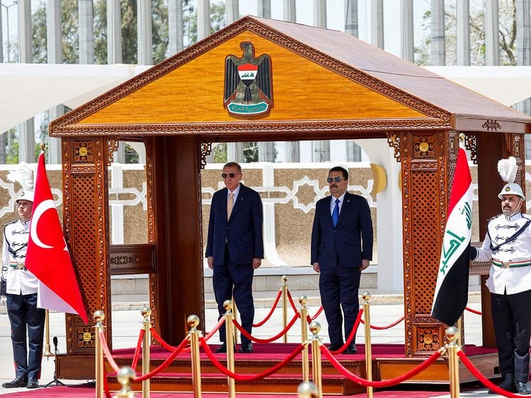 Iraq's Prime Minister Mohammed Shia Al Sudani (right) and Turkey's President Recep Tayyip Erdogan take part in a welcoming ceremony at the Baghdad International airport in Iraq's capital on April 22, 2024.  