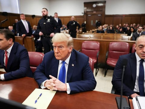 Former US president and Republican presidential candidate Donald Trump awaits the start of proceedings for allegedly covering up hush money payments linked to extramarital affairs at Manhattan Criminal Court in New York, on April 22, 2024.  