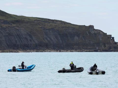 People on boats in Wimereux, near Calais, after migrants died in an attempt to cross the English Channel, in France, April 23, 2024.  