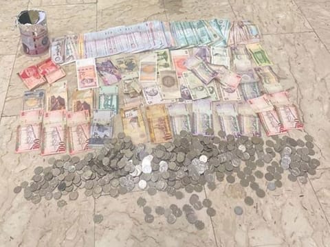 Dubai Police display a large amount of cash found in the possession of a beggar