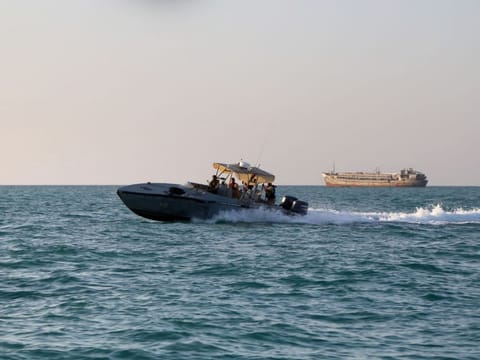Yemeni coastguards loyal to the internationally-recognised government ride in a patrol boat in the Red Sea off the government-held town of Mokha in the western Taiz province, close to the strategic Bab Al Mandab Strait, on April 15, 2024.  In recent months Saudi Arabia has begun accepting guests at two resorts as part of its Red Sea Global coastal development, while the luxury yachting island Sindalah - part of the futuristic NEOM megacity - is expected to be completed by the end of this year.