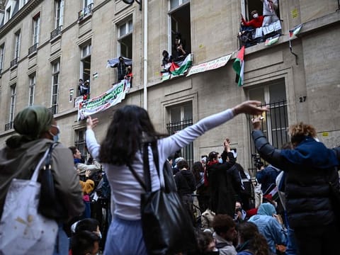 Protesters dance as they stage a sit-in near the entrance of a Institute of Political Studies (Sciences Po Paris) building occupied by students, in Paris.  