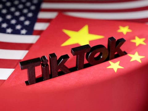 TikTok logo is placed on the US and Chinese flags in this illustration. 