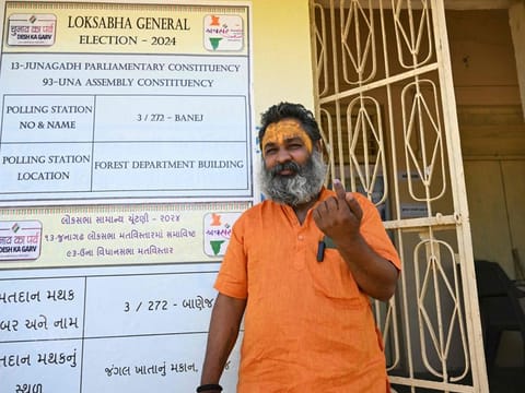 Hindu monk Mahant Haridas Udaseen, the sole registered voter at a polling station situated inside Gir Forest shows his inked finger after casting his ballot during the third phase of voting of Indias general elections in Banej, Gujarat , on May 7, 2024.  