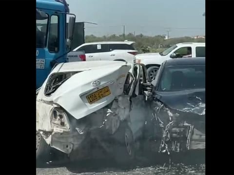 The truck (partially seen on the left) and the vehicles involved in the deadly crash.