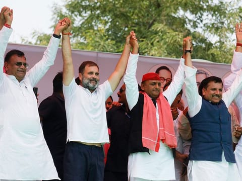 Congress leader Rahul Gandhi, Samajwadi Party (SP) chief and party candidate from Kannauj seat Akhilesh Yadav, Aam Aadmi Party (AAP) leader Sanjay Singh and others hold hands during the public meeting for the Lok Sabha elections, in Kannauj on Friday. 