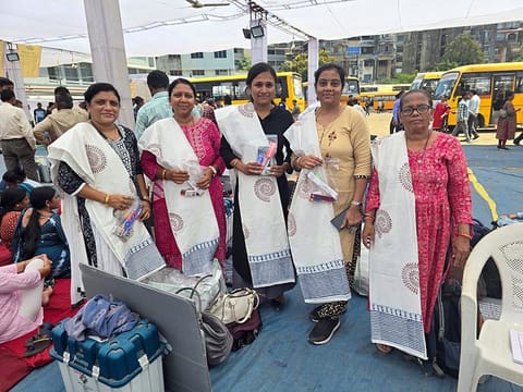 Valsad, May 06 (ANI): Polling officials pose for a picture after collecting the EVMs and other election materials for the 3rd phase of the Lok Sabha polls, in Valsad on Monday. 