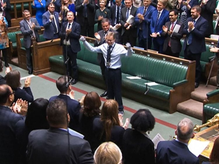  A video grab from footage broadcast by the UK Parliament's Parliamentary Recording Unit (PRU) shows Britain's Conservative MP Craig Mackinlay acknowledging the applauses and cheering, in the House of Commons, in London, on May 22, 2024 on the day of his coming back ahead of the weekly session of Prime Minister's Questions (PMQs) in the House of Commons.  