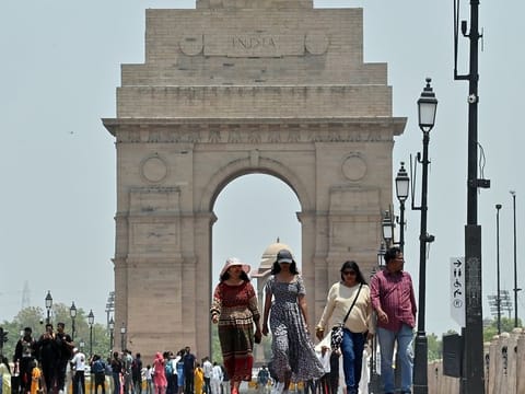 File photo: People walk on Kartavya Path near India while covering themselves to protect from the scorching heat on a hot summer day, in New Delhi. 