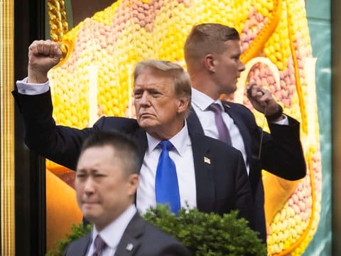 Former US President Donald Trump gestures following the announcement of the verdict of his criminal trial over charges that he falsified business records to conceal money paid to silence porn star Stormy Daniels in 2016, outside Trump Tower, in New York City, on May 30, 2024. 