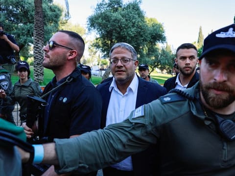 Israel's National Security Minister Itamar Ben-Gvir with his guards  in Jerusalem. Ben Gvir said on X his party would “dissolve the government”.