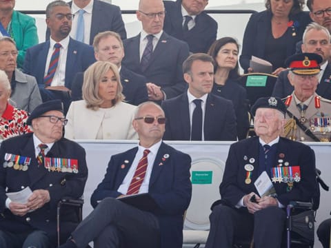 French President's wife Brigitte Macron, France's President Emmanuel Macron, Britain's King Charles III, former French prime minister Elisabeth Borne (3rd row left) and British veterans (front) attend the UK Ministry of Defence and the Royal British Legions commemorative ceremony marking the 80th anniversary of the World War II "D-Day" Allied landings in Normandy, at the World War II British Normandy Memorial near the village of Ver-sur-Mer which overlooks Gold Beach in northwestern France, on June 6, 2024.  