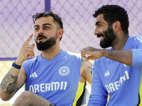 Virat Kohli and Jasprit Bumrah discuss during a practice session ahead of India's World Cup match.