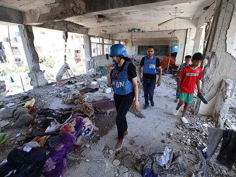 Members of a United Nations investigation team visit a school run by the UN Relief and Works Agency for Palestine Refugees (UNRWA) which was hit during an Israeli army strike the day before, in the Nuseirat camp in the central Gaza Strip on June 7, 2024, amid the ongoing conflict in the Palestinian territory between Israel and Hamas. 