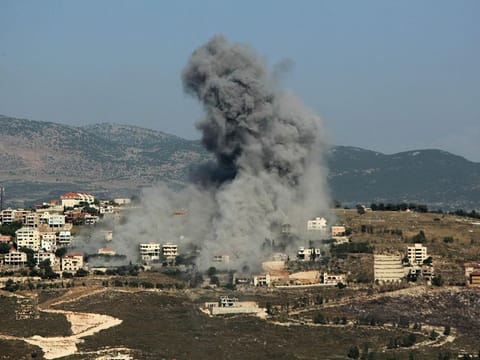 Smoke billows from the site of an Israeli airstrike .