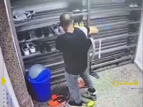 The thief trying out shoe at a mosque in Kuwait.