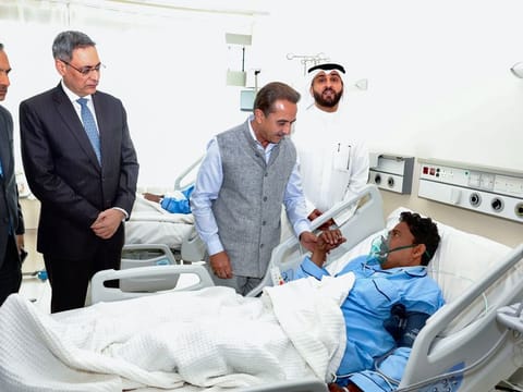 India's federal Minister of State for External Affairs Kirti Vardhan Singh meets an Indian who was injured in the Mangaf fire incident, at Jaber Hospital, in Kuwait on Thursday.  