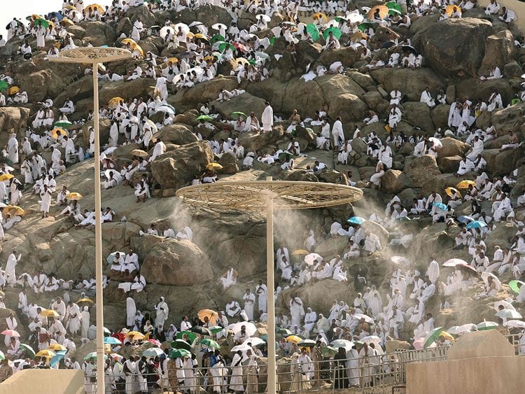 Mist dispensers refreshen pilgrims as they walk up Saudi Arabia's Mount Arafat, also known as Mount of Mercy, during the Hajj pilgrimage on June 15, 2024. 