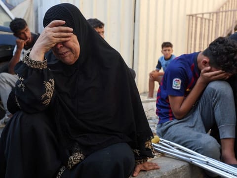Mourners at a funeral of Palestinians killed in Israeli strikes at Al Aqsa hospital in Deir Al Balah, in the central Gaza Strip, on June 18, 2024.  