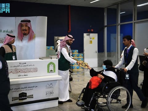Departing pilgrims get a copy of Quran as they depart the King Abdul Aziz airport in Jeddah.