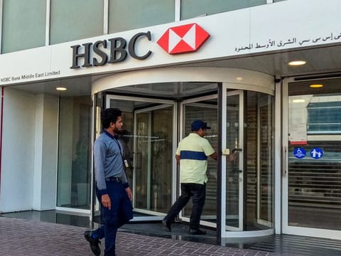 HSBC bank customers walking into the lender's branch located in Sharjah.