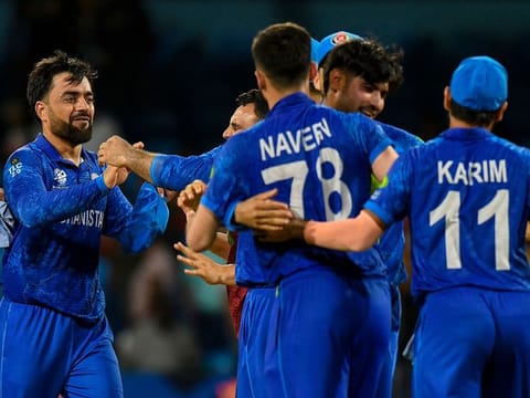 Afghanistan's captain Rashid Khan (left) celebrates his team's win of against Australa during the Super Eight stage of the Twenty20 World Cup.