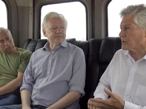 WikiLeaks founder Julian Assange (centre) sits in a vehicle at a location given as Bangkok in this screengrab from a video released to social media on June 25, 2024.  