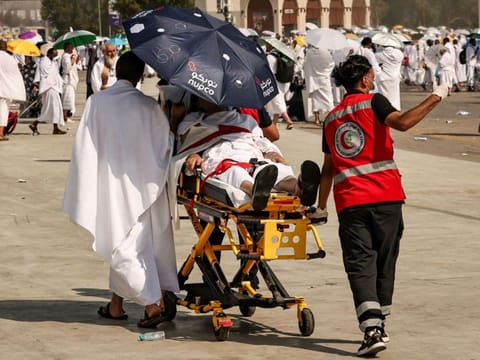 Medical team members evacuate a pilgrim, affected by the soarching heat, at the base of Mount Arafat during the annual hajj pilgrimage on June 15, 2024.  