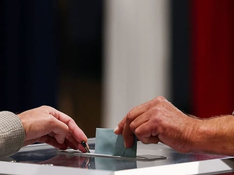 A voter casts their ballot, during the French parliamentary elections at a polling station in Le Touquet-Paris-Plage, France