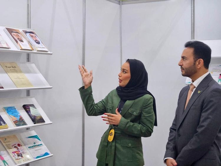 Abdulla-Saif-Al-Nuaimi,-Ambassador-of-the-UAE-to-the-Republic-of-Korea,-and-Khoula-Al-Mujaini,-Director-of-Events-and-Marketing-at-SBA-during-the-Ambassador's-visit-to-the-Sharjah-Book-Authority's-stand-1719919838236