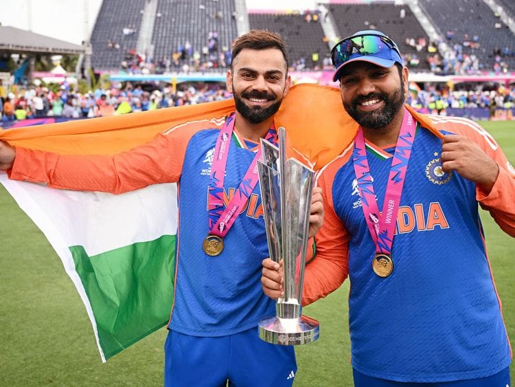 India’s captain Rohit Sharma (right) and Virat Kohli pose with the T20 World Cup after beating South Africa by seven runs in the final at Kensington Oval in Barbados on June 29, 2024. Rohit and Kohli retired from T20 Internationals after the match.