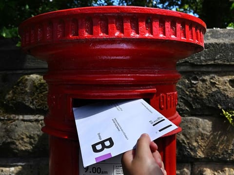 An envelope containing a Postal Vote for the upcoming UK General Election is posted in Birkenhead, north west England. 