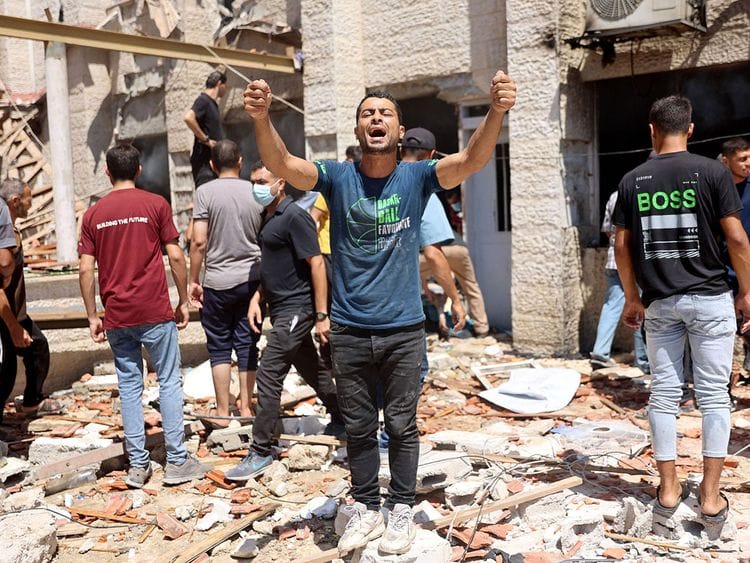 Palestinian rescuers search the rubble and debris of the Latin Patriarchate Holy Family School after it was hit during Israeli military bombardment, in Gaza City on July 7, 2024.